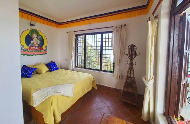 Peace Dragon Lodge. Double bed. Mountain views.